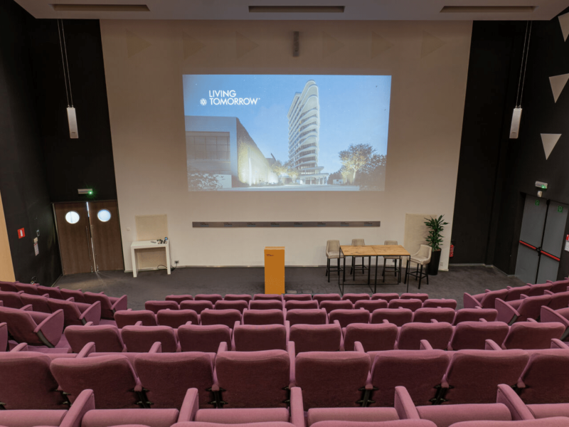 Aula with purple chairs and living tomorrow/voco building projected