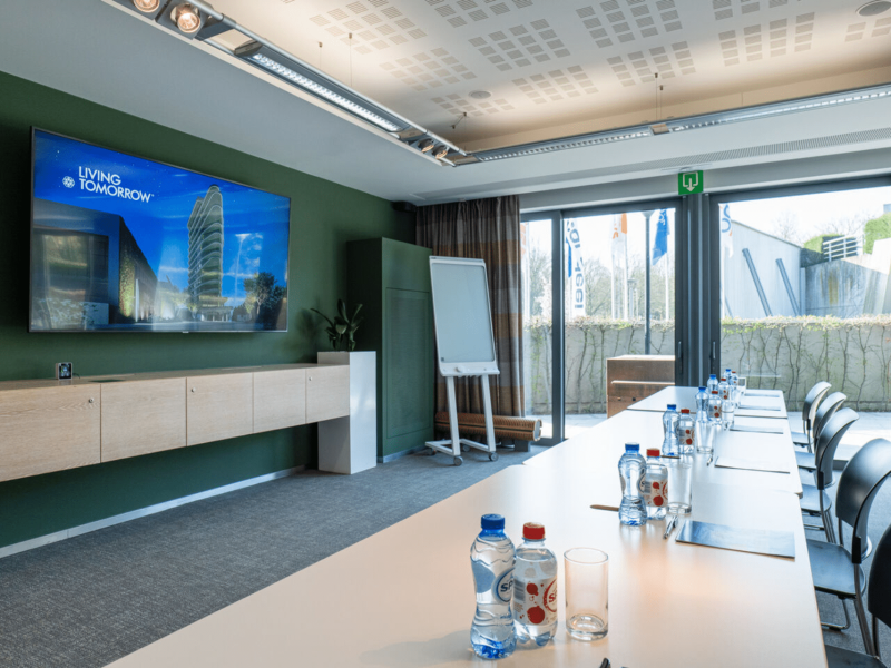 Meeting room at voco with bottles on table and tv screen