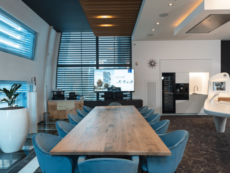 Meeting room with a wooden table with blue chairs