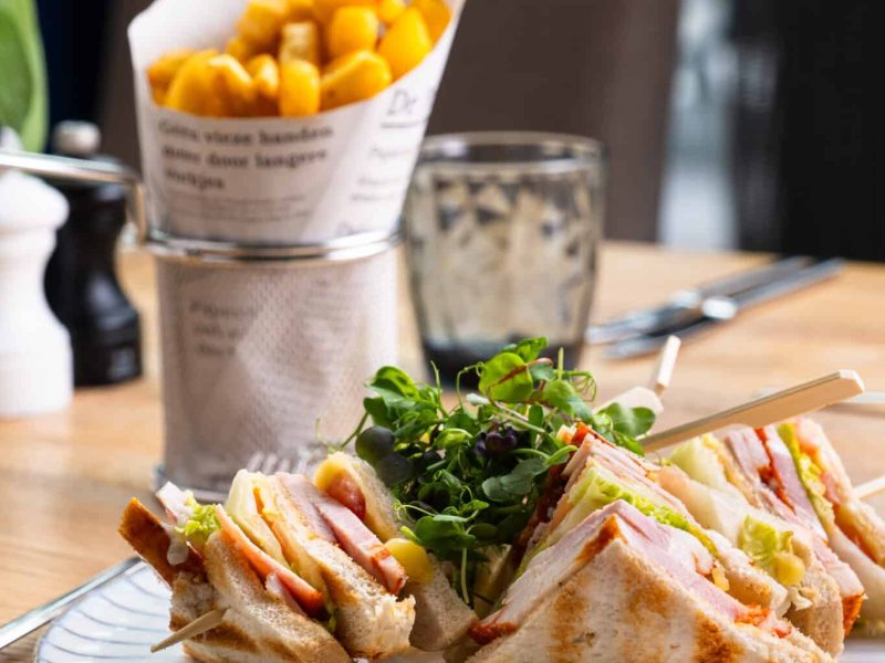 club sandwich with fries on a table