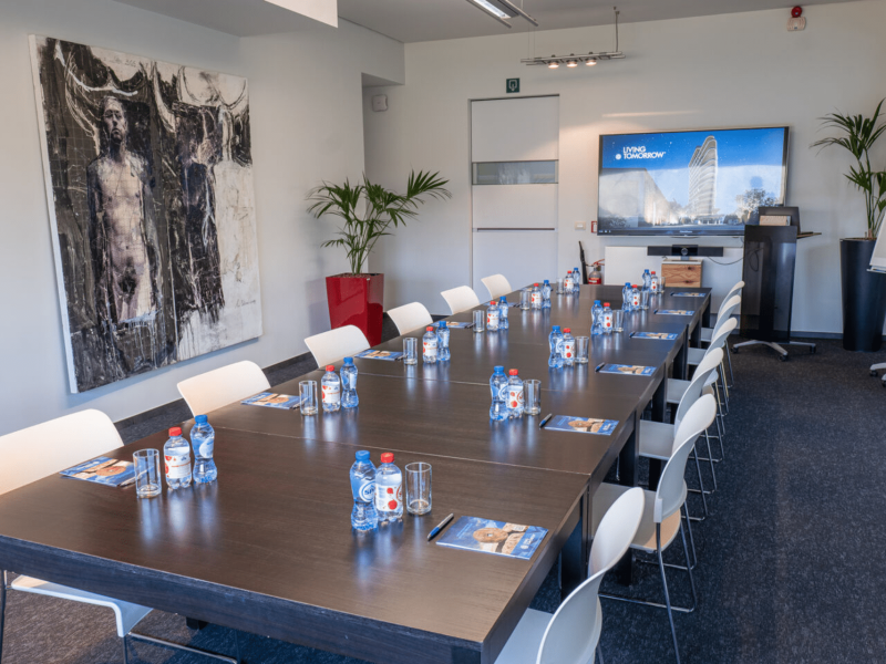 Meeting room at voco with bottles on table and tv screen