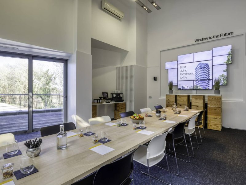 The Globe Meeting Room voco Brussels City North with funky tv screen, meeting stationary and a coffee corner