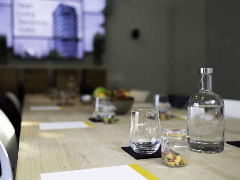 The Globe Meeting Room table with glasses and a jar with nuts at each seat