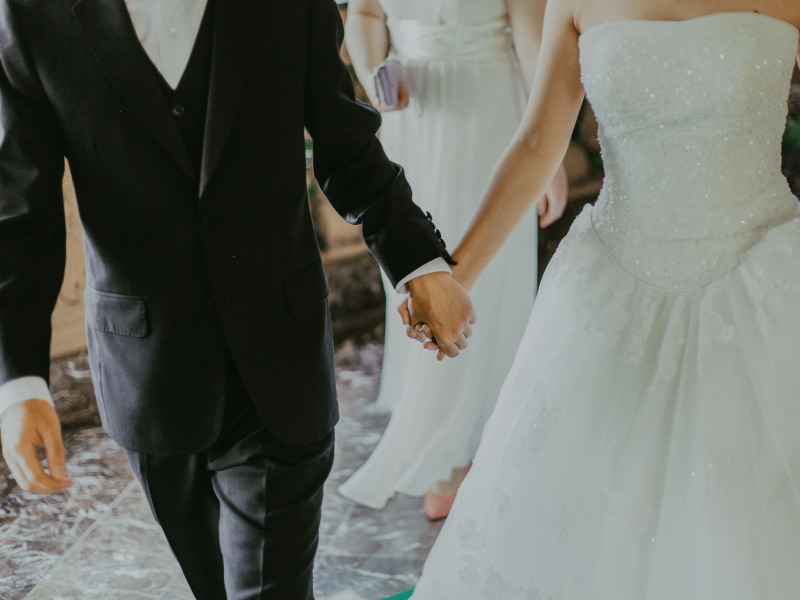 bride and groom holding hands at wedding